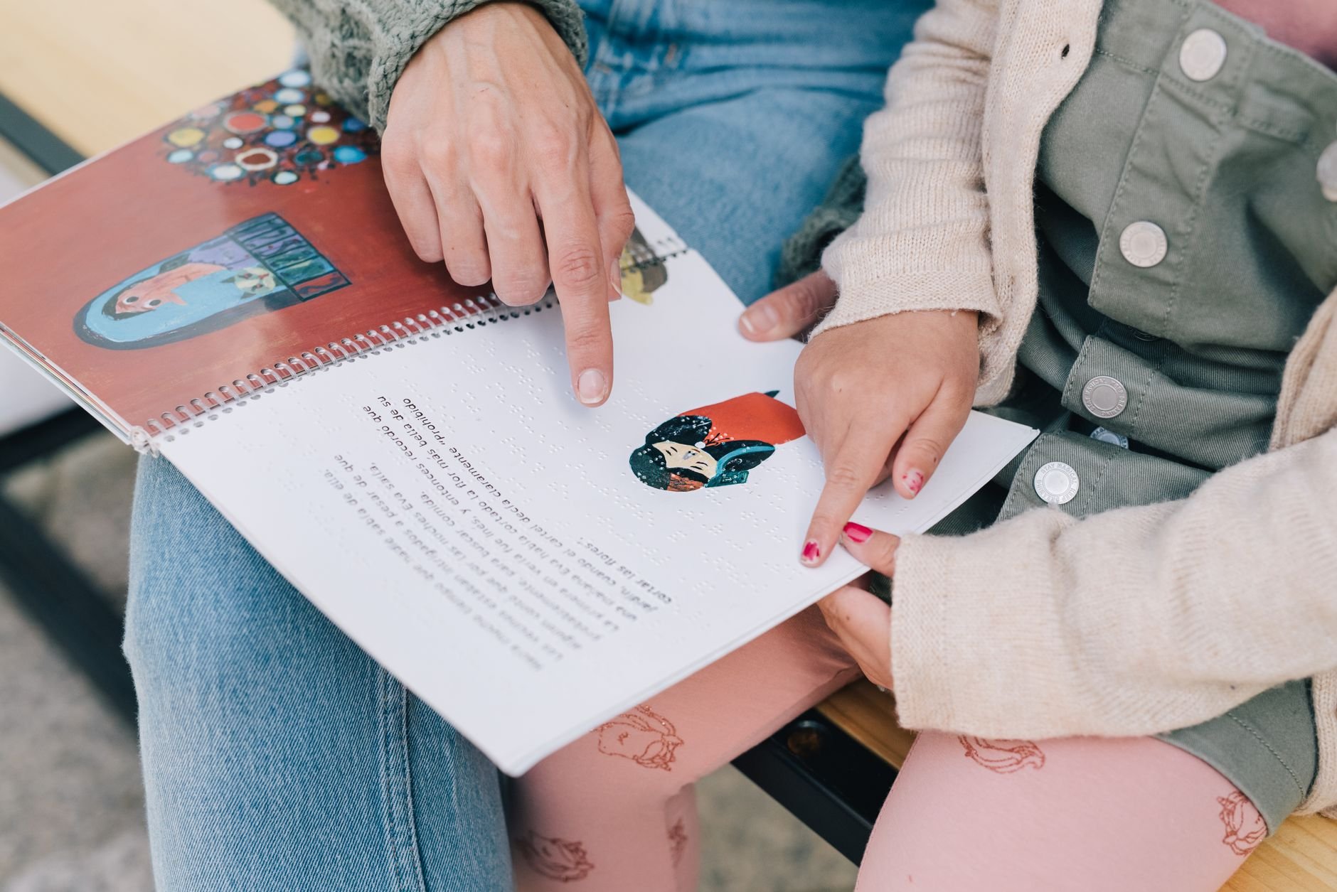 A mother and child reading a story together outdoors, fostering bonding and learning.